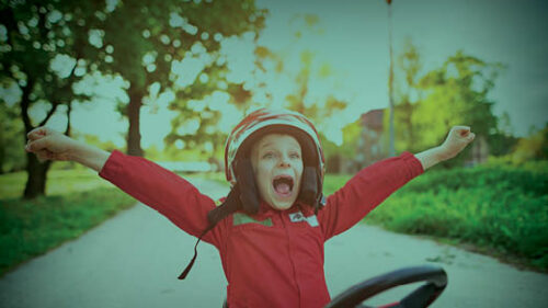 A child happily playing in a car