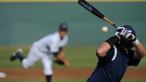 Baseball players swinging a baseball bat.