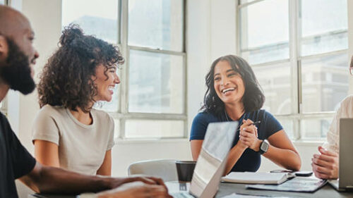 Three business professionals at a conference table.