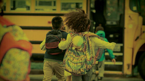 A girl running to the school bus