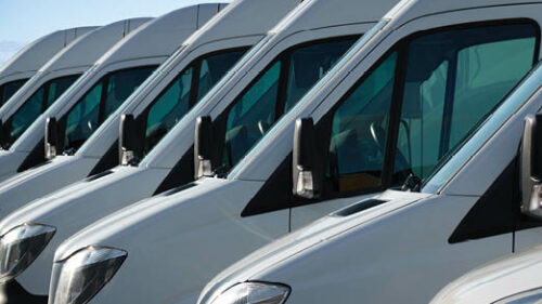 A line of parked commercial vans