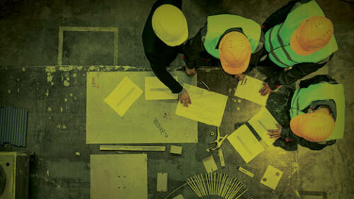 men discussing surety bonds at a construction site.