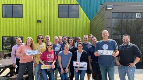 A group of CSDZ employees celebrating being part of the Holmes Murphy enterprise and their 90th anniversary through volunteering.