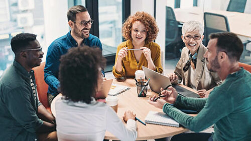 A group of professionals sitting around a table discussing insurance