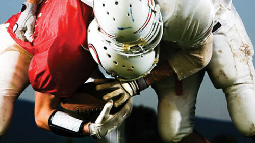 two football players tackling