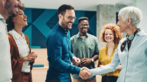 A diverse group of employees smiling and laughing