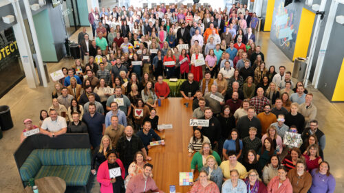 A group photo of Holmes Murphy employees in their main room of their office.