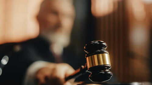 A judge banging his gavel in court