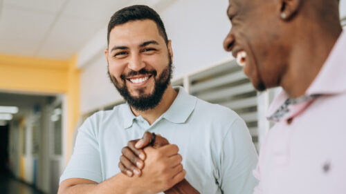 Two business professionals laughing