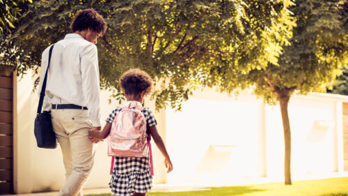 An employee walking with his child.